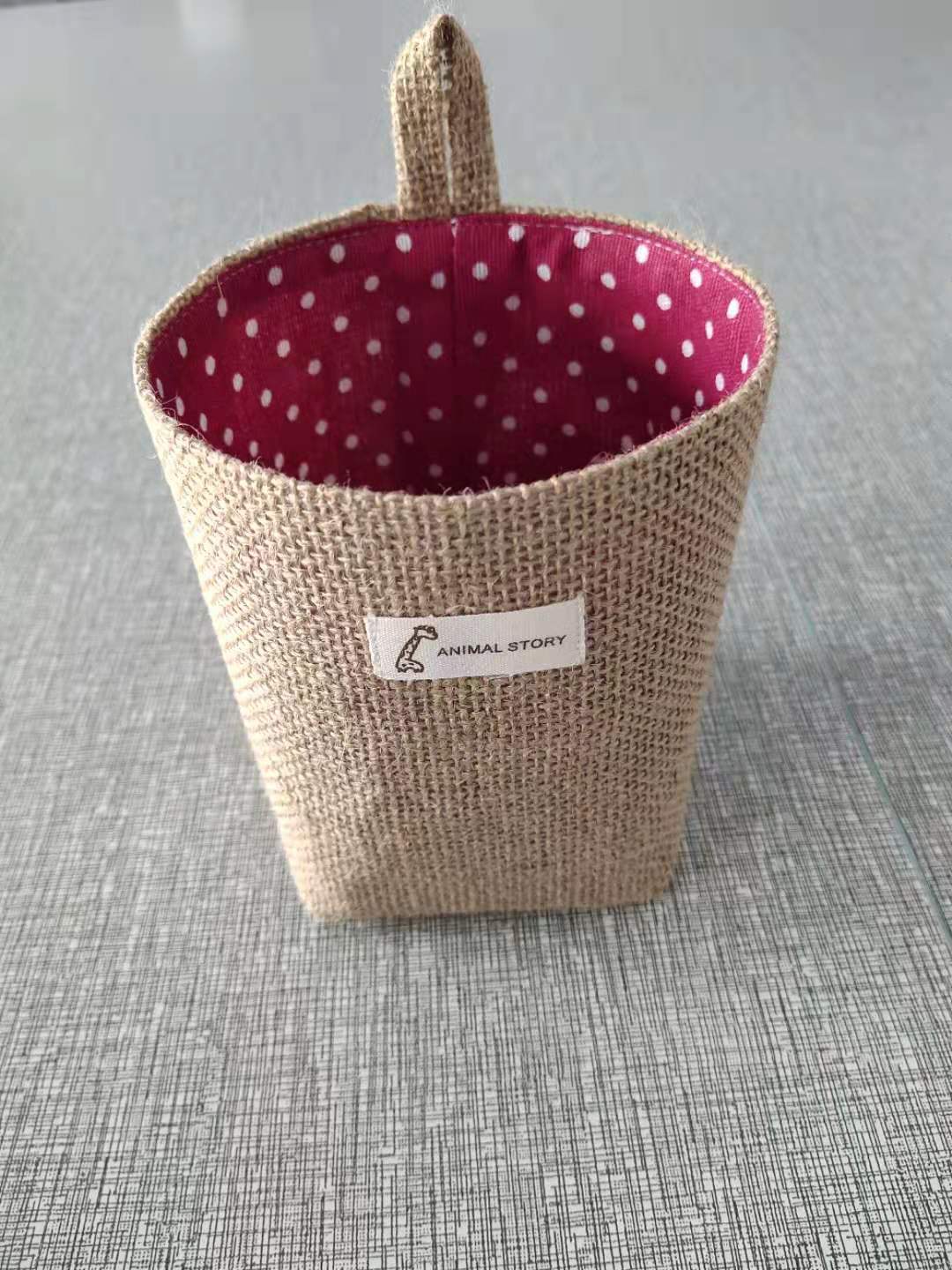 Wall-mounted jute storage bag for home organisation