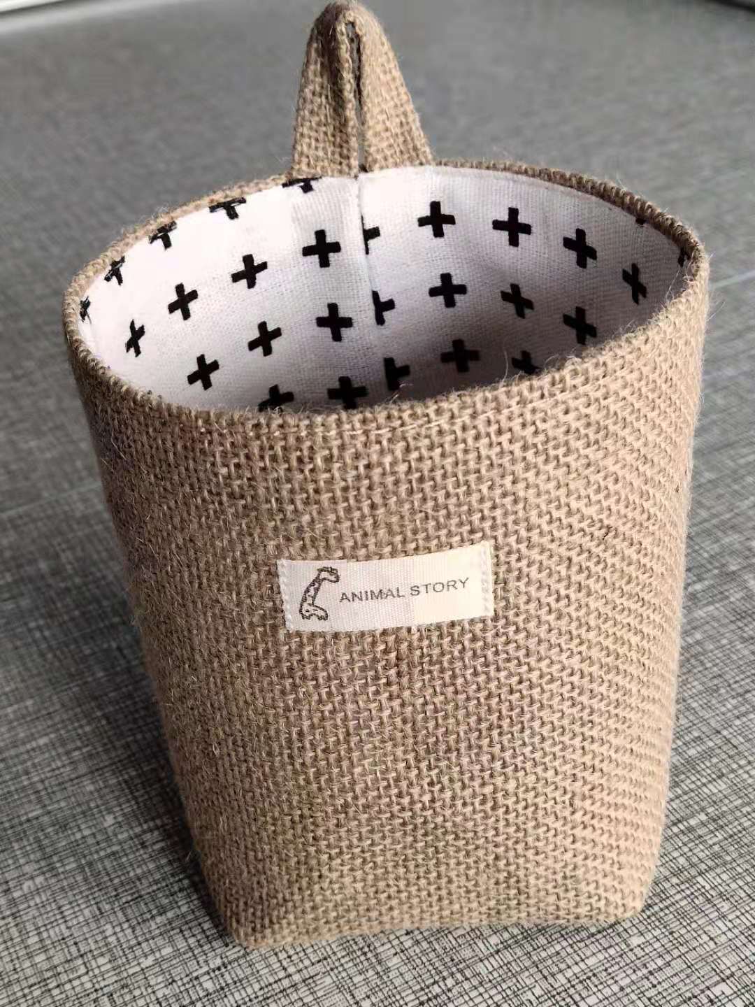 Wall-mounted jute storage bag for home organisation